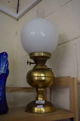 Lot 592 - Oil lamp with white glass shade