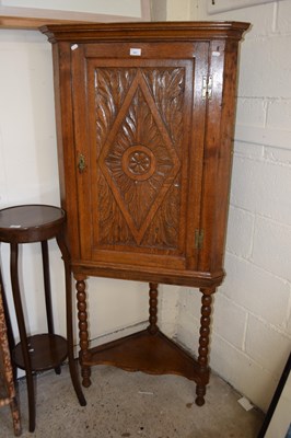 Lot 384 - Georgian oak corner cabinet with later carving...