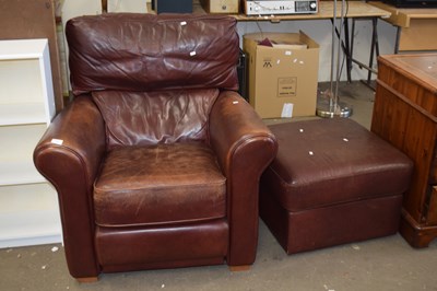 Lot 779 - A leather armchair and matching footstool