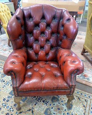 Lot 435 - A distressed red leather Chesterfield style...