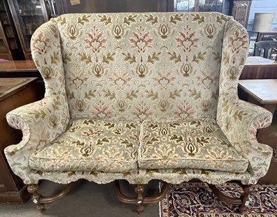 Lot 511 - A Carolean style wing back sofa with floral...