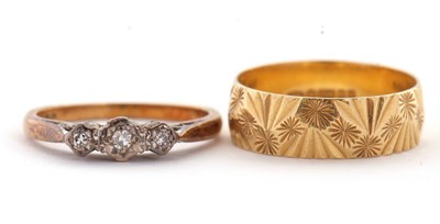 Lot 34 - Two 18ct rings, the first a wedding band with...