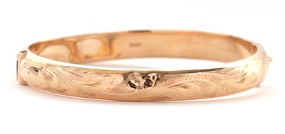 Lot 104 - A 9ct hinged bangle, the upper half with...