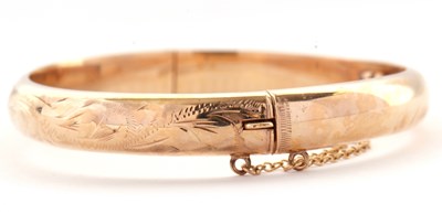 Lot 104 - A 9ct hinged bangle, the upper half with...