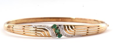 Lot 54 - A 9ct emerald and diamond bangle, the hinged...