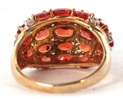 Lot 21 - A 9ct gemset ring, the bombe style ring set...