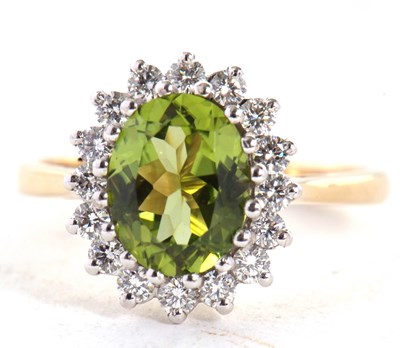Lot 25 - An 18ct peridot and diamond cluster ring, the...