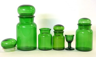 Lot 654 - Group of green glass jars and a small eye bath