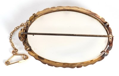 Lot 51 - A chalcedony brooch, the oval off white...