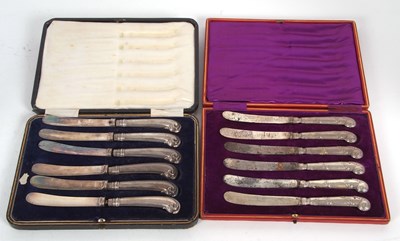 Lot 184 - Mixed Lot: Two cases of silver pistol handled...