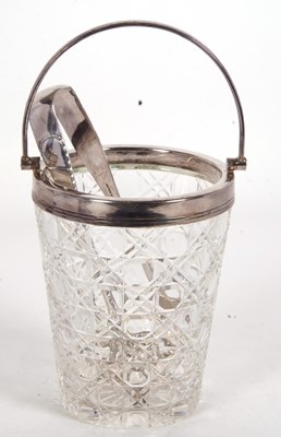 Lot 201 - A vintage cut glass ice bucket with silver...