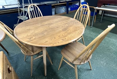 Lot 199 - An Ercol drop leaf circular dining table with...