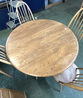 Lot 199 - An Ercol drop leaf circular dining table with...