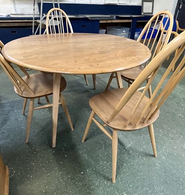 Lot 199 - An Ercol drop leaf circular dining table with...