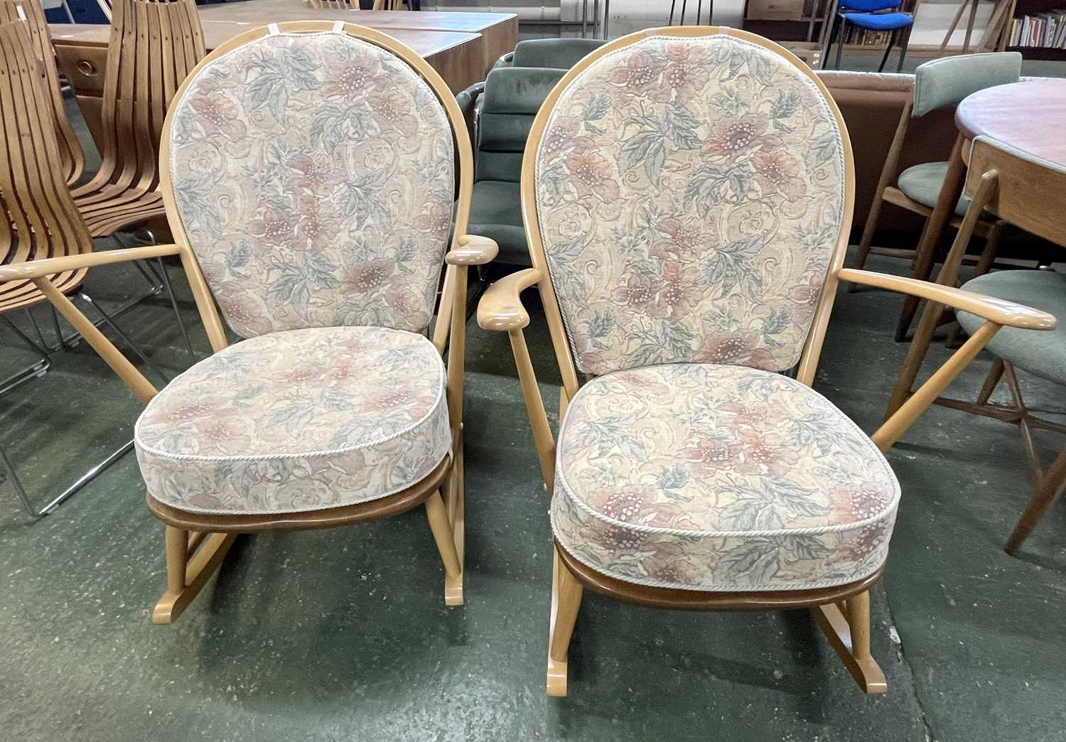 Lot 223 - A pair of Ercol light wood rocking chairs with...