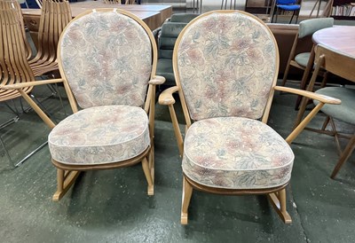 Lot 223 - A pair of Ercol light wood rocking chairs with...