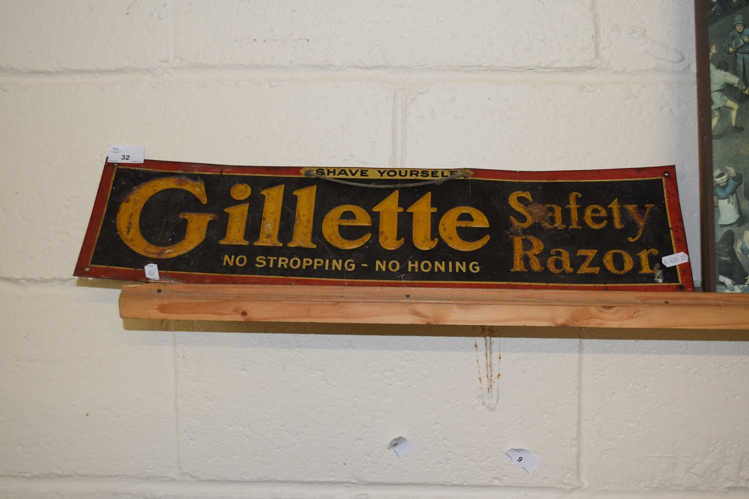 Lot 32 - A metal and card backed advertising sign for...