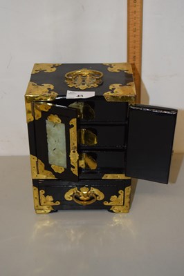 Lot 43 - A modern Oriental black lacquered and brass...