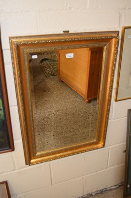 Lot 222 - A modern rectangular bevelled wall mirror in...