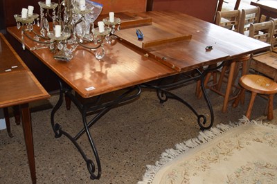 Lot 280 - An extending dining table on iron frame