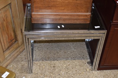 Lot 342 - A nest of three metal framed glass top tables