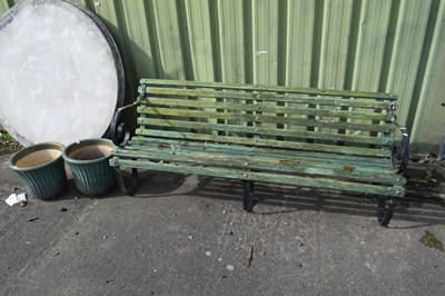 Lot 1125 - A wooden garden bench with iron ends