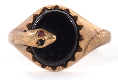Lot 10 - A 9ct onyx snake ring, the oval claw mounted...