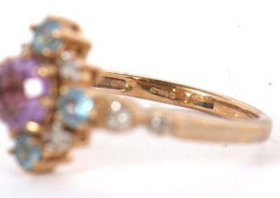Lot 18 - A 9ct amethyst, topaz and diamond ring, the...
