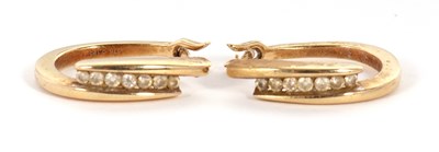 Lot 59 - A pair of 9ct diamond earrings, the oval hoops...
