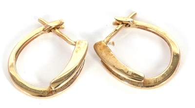 Lot 59 - A pair of 9ct diamond earrings, the oval hoops...