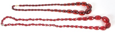 Lot 141 - Two 'cherry amber' bead necklaces, one with...