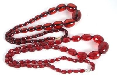 Lot 141 - Two 'cherry amber' bead necklaces, one with...