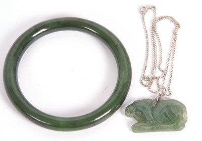 Lot 117 - A jade bangle and pendant, the bangle with...