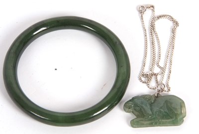 Lot 117 - A jade bangle and pendant, the bangle with...