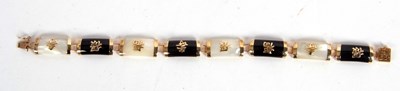 Lot 140 - An onyx and mother-of-pearl bracelet, the...