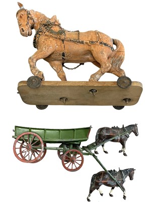 Lot 99 - A composite model horse on wooden wheeled base...