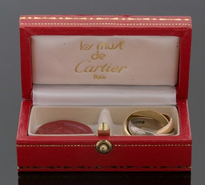 Lot 367 - An 18ct Cartier trinity ring, the white,...