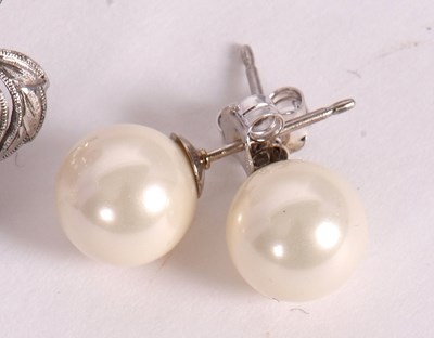 Lot 109 - A pair of cultured pearl earrings, modelled as...