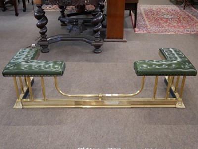 Lot 524 - Brass club fender with green leather top over...