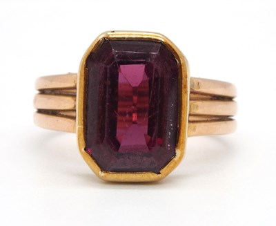 Lot 9 - An unmarked garnet ring, the step cut garnet...