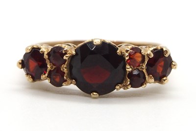 Lot 8 - A 9ct garnet ring, the three principal...