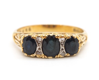 Lot 16 - An 18ct sapphire and diamond ring, the three...