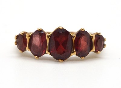 Lot 5 - A 9ct garnet ring, the five oval graduated...