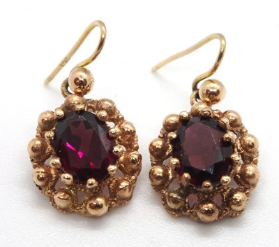 Lot 92 - A pair of garnet earrings, the oval claw...