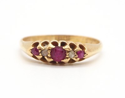 Lot 68 - An 18ct ruby ring, the three round graduated...