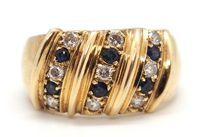 Lot 32 - A sapphire and diamond ring, the broad 11mm...