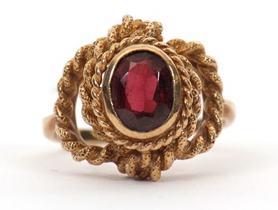 Lot 47 - A 9ct garnet ring, the oval faceted garnet in...