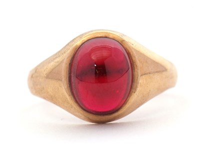 Lot 48 - A 9ct garnet ring, the oval garnet cabochon in...