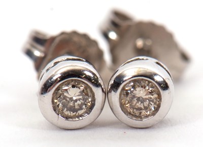 Lot 197 - A pair of 9ct white gold diamond earstuds, the...