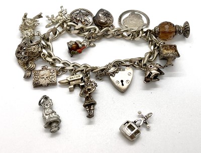 Lot 198 - A silver charm bracelet, the curblink bracelet...